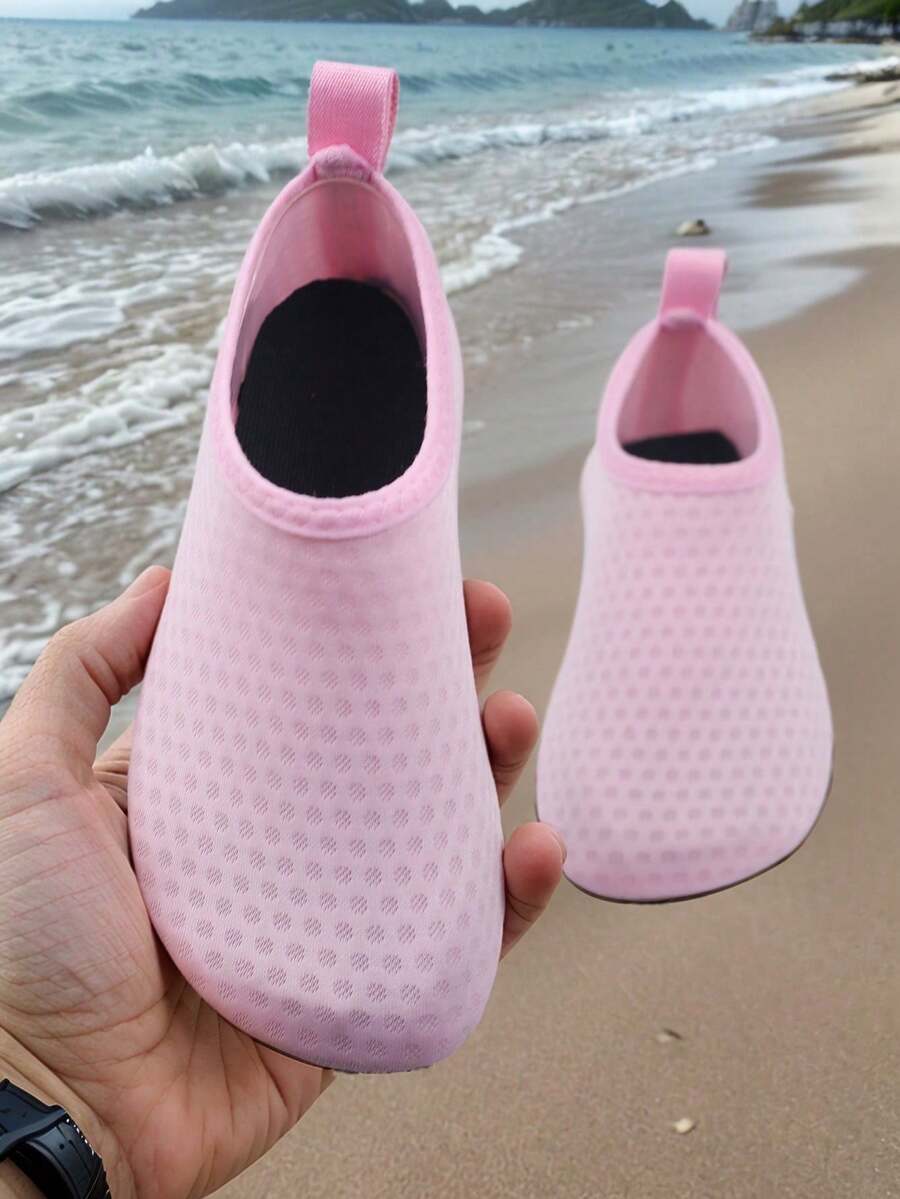 Pair of lightweight slip-on kids water shoes with breathable upper and non-slip outsole for summer beach and pool wear.