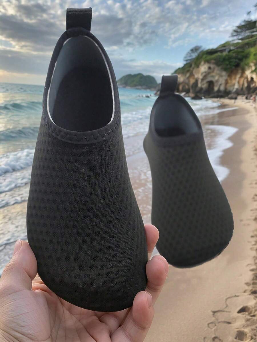 Pair of lightweight slip-on kids water shoes with breathable upper and non-slip outsole for summer beach and pool wear.
