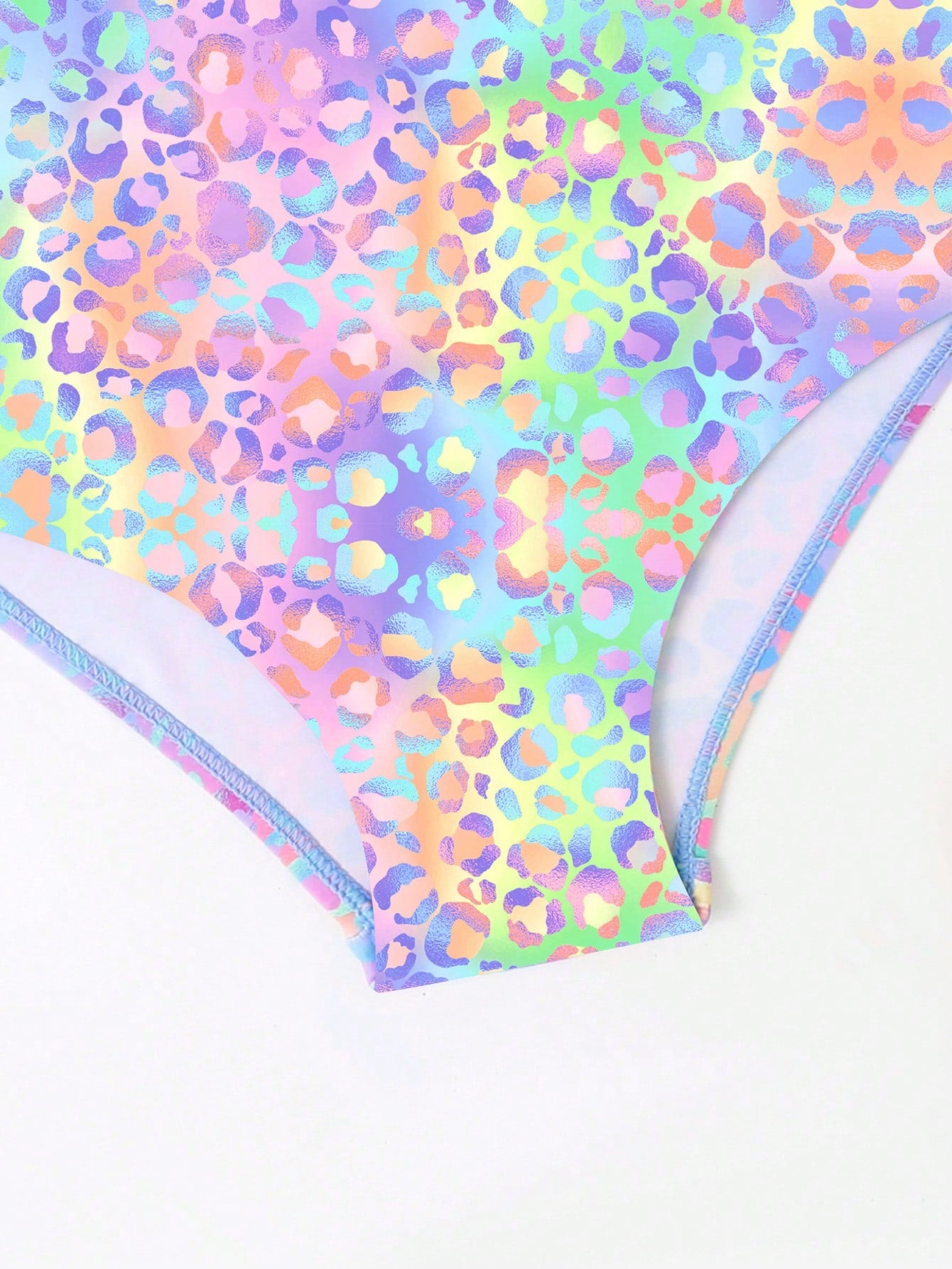 Girls' multicolor ombre leopard print one-piece swimsuit with scoop neck, ruffle detail, and criss-cross back design for summer pool wear.