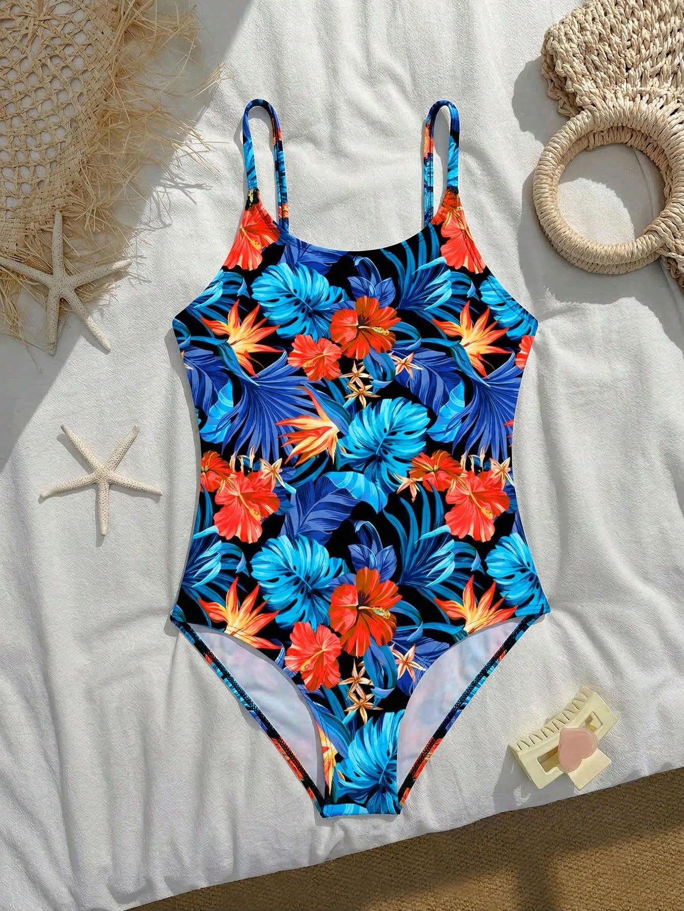 Tween girls one-piece swimsuit with a floral plant print, spaghetti straps, and a mid-waist fit in black.