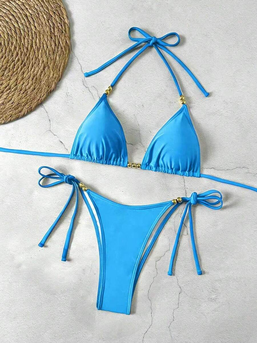 Women's black halter bikini set featuring triangle cups with gold bead decor and tie-back closure