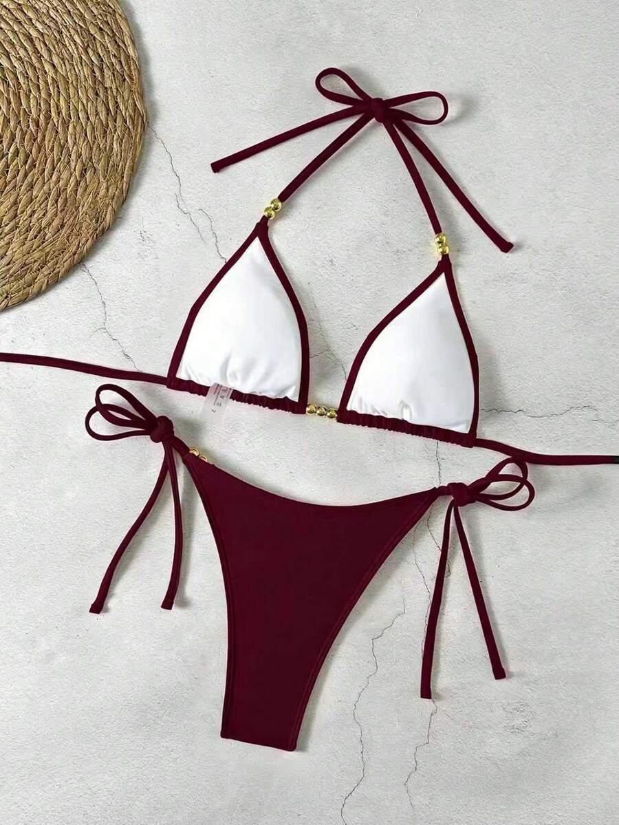 Women's black halter bikini set featuring triangle cups with gold bead decor and tie-back closure