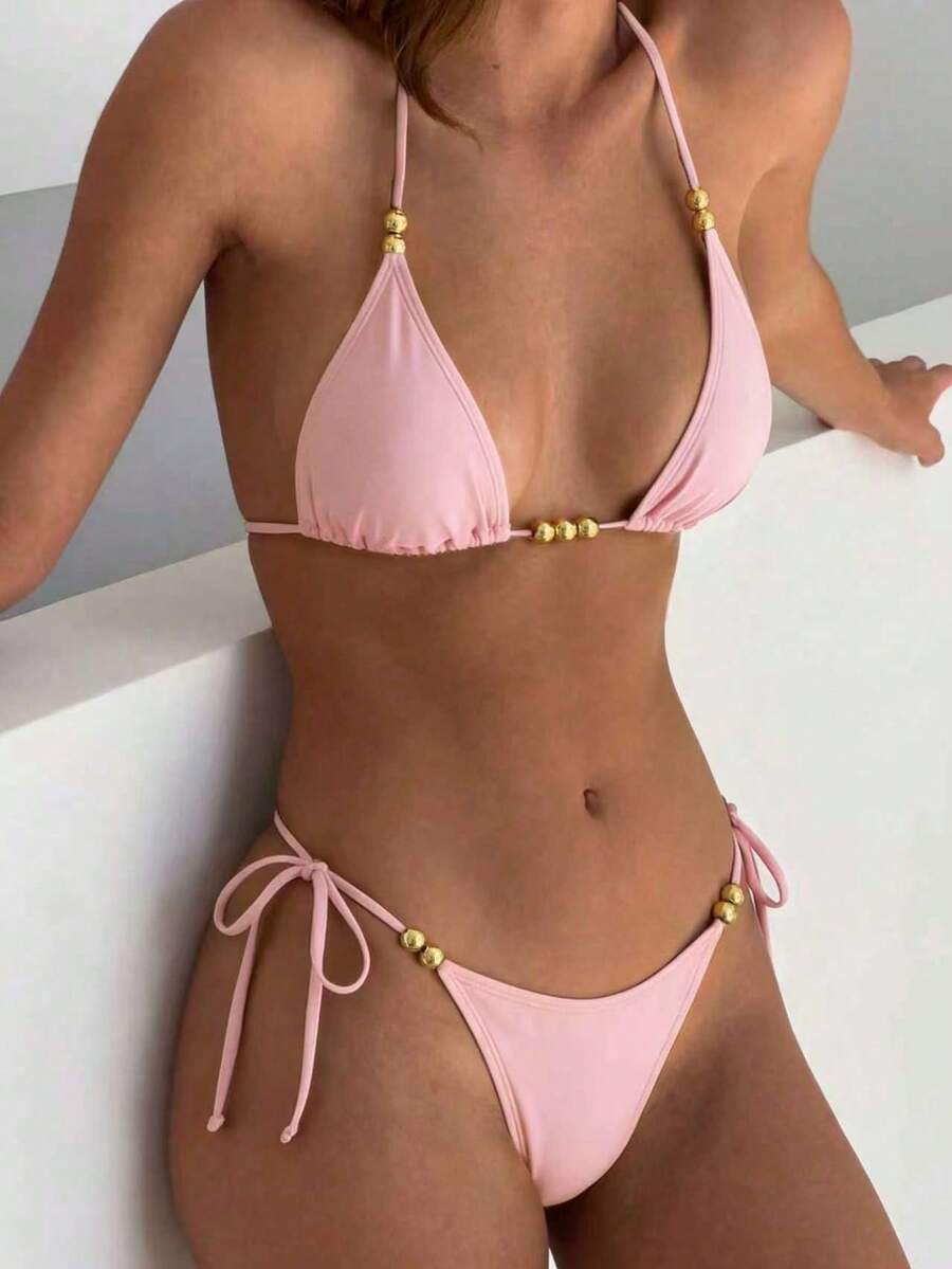 Women's black halter bikini set featuring triangle cups with gold bead decor and tie-back closure