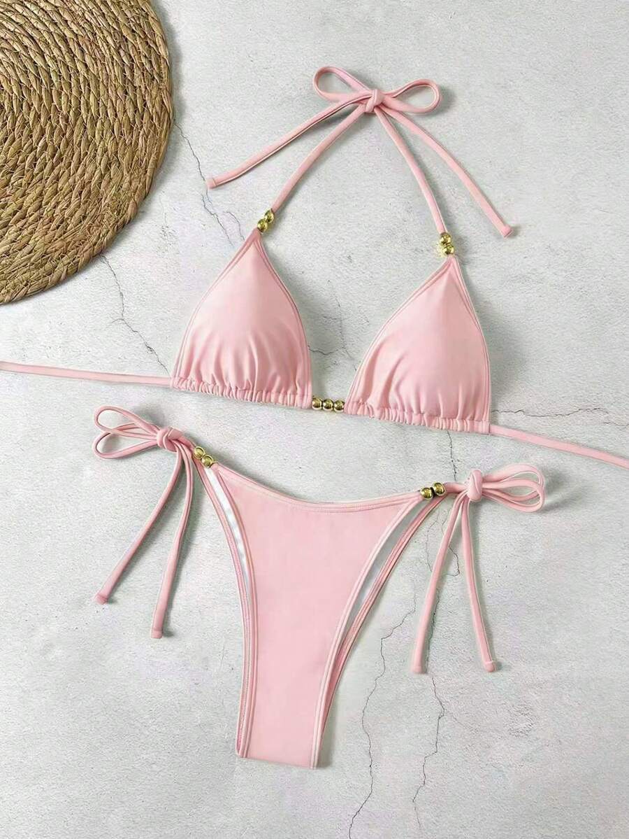 Women's black halter bikini set featuring triangle cups with gold bead decor and tie-back closure