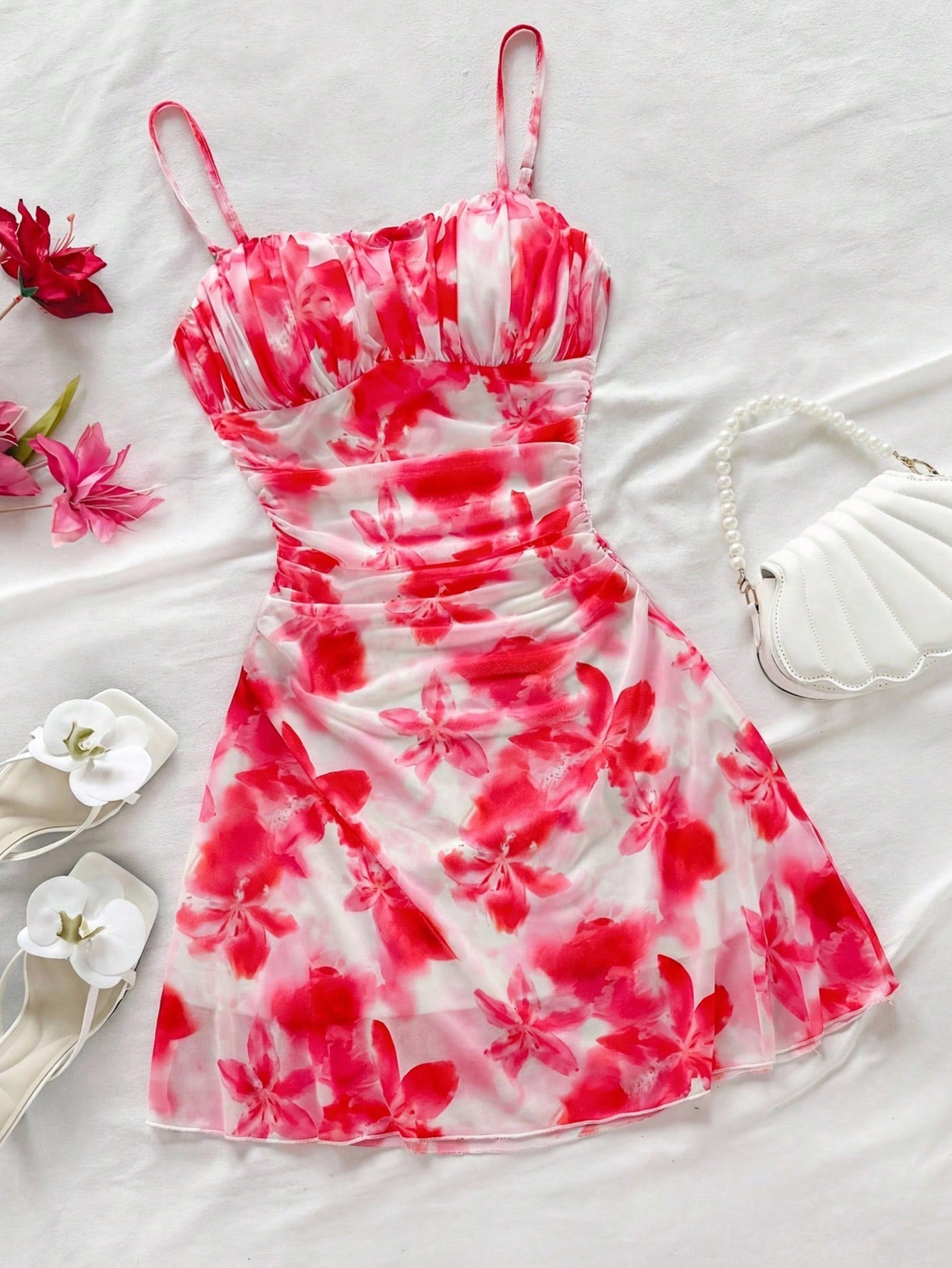 Tween girl yellow mini sundress with large pink floral hibiscus print, spaghetti straps, high waist, flared hem, and sleeveless cami style for summer beach wear