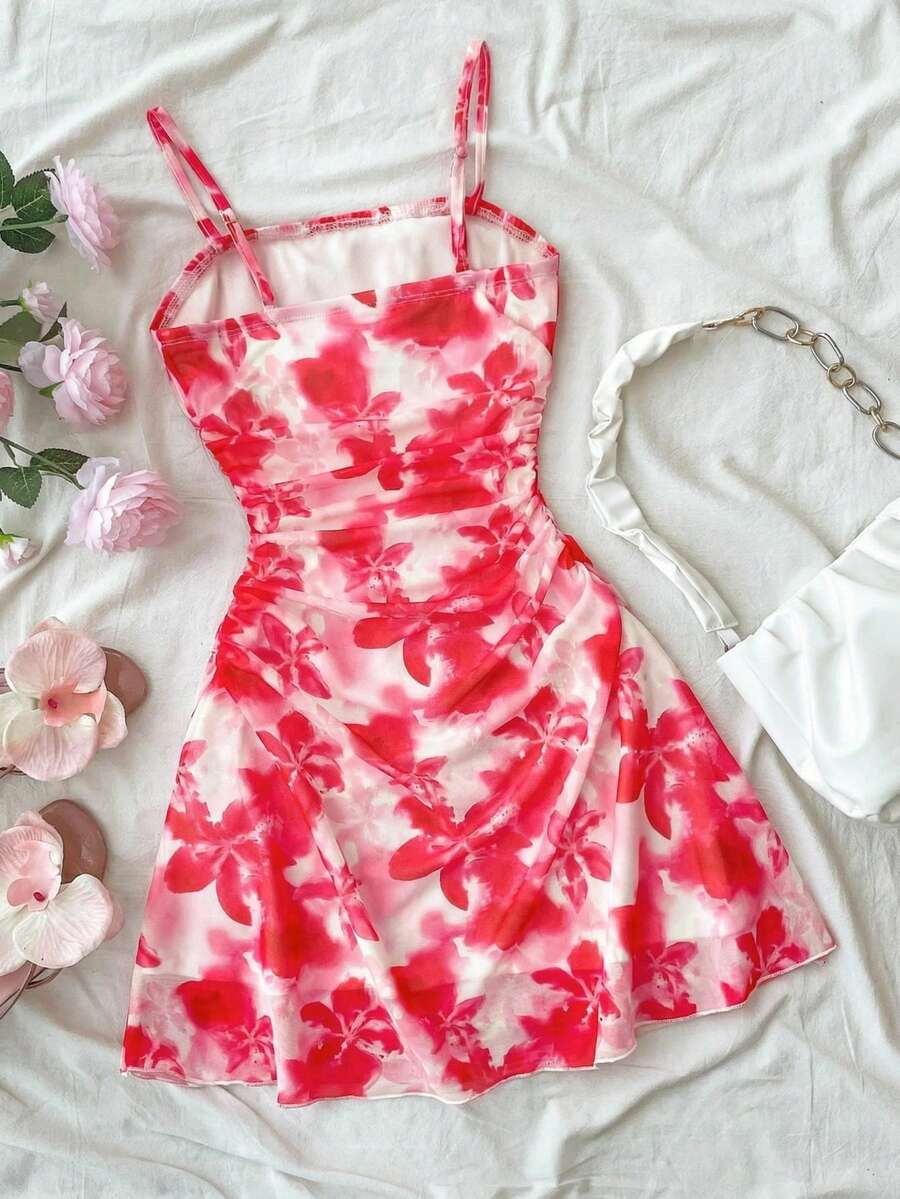 Tween girl yellow mini sundress with large pink floral hibiscus print, spaghetti straps, high waist, flared hem, and sleeveless cami style for summer beach wear