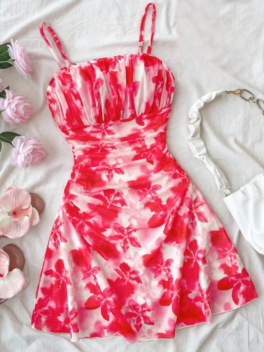 Tween girl yellow mini sundress with large pink floral hibiscus print, spaghetti straps, high waist, flared hem, and sleeveless cami style for summer beach wear