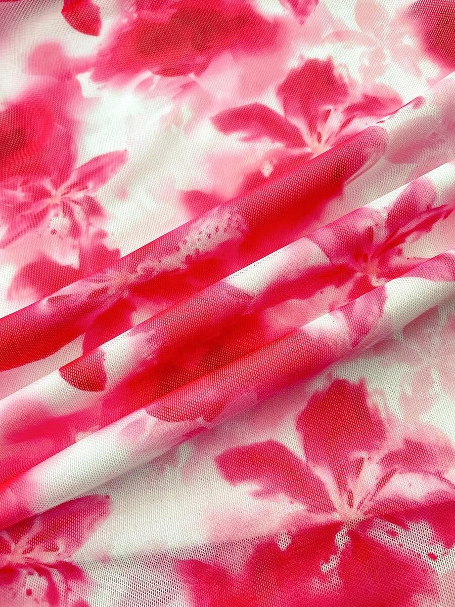 Tween girl yellow mini sundress with large pink floral hibiscus print, spaghetti straps, high waist, flared hem, and sleeveless cami style for summer beach wear