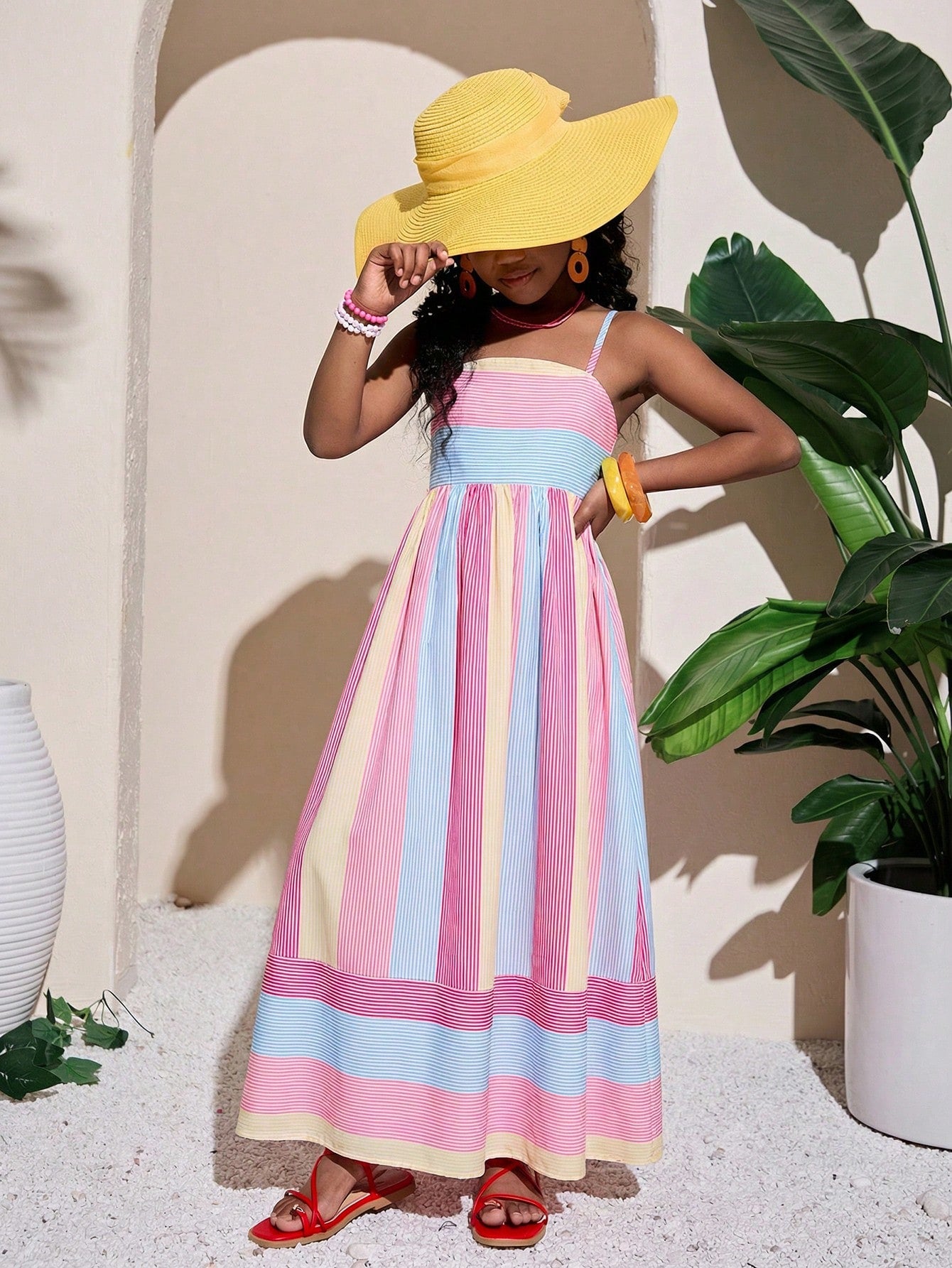 Tween girls striped spaghetti strap cami dress with high waist, shirred detail, zipper closure, sleeveless design, and flared long A-line silhouette for vacation wear.