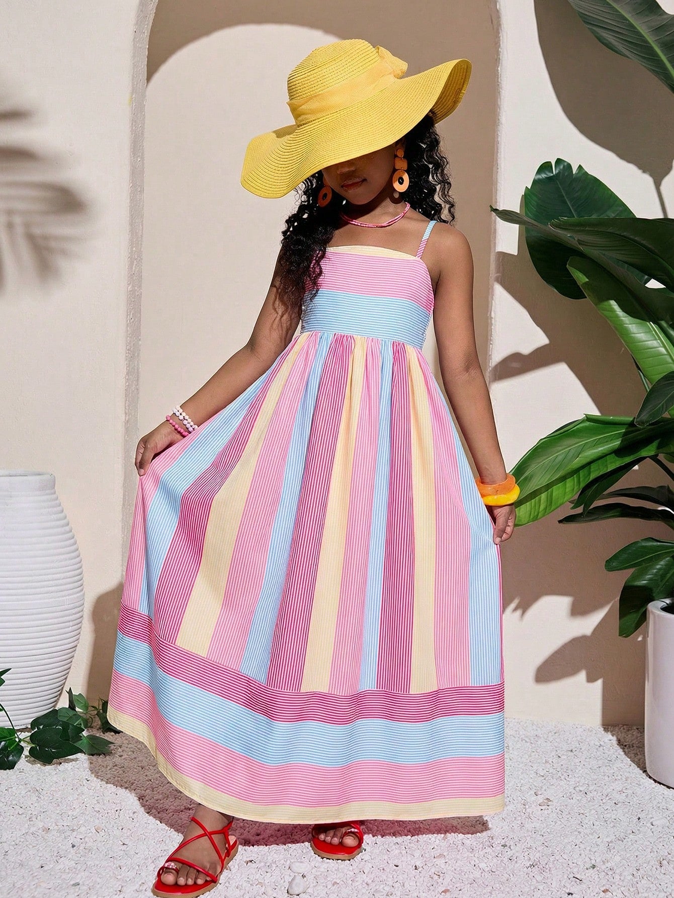Tween girls striped spaghetti strap cami dress with high waist, shirred detail, zipper closure, sleeveless design, and flared long A-line silhouette for vacation wear.