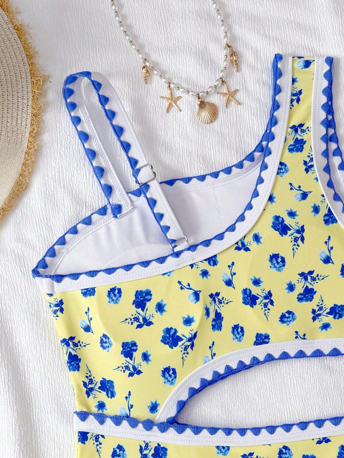 Tween girls one-piece swimsuit featuring an asymmetric neckline, pendant decor, plain design, wireless bra, high-cut bottom, and medium-stretch fabric.