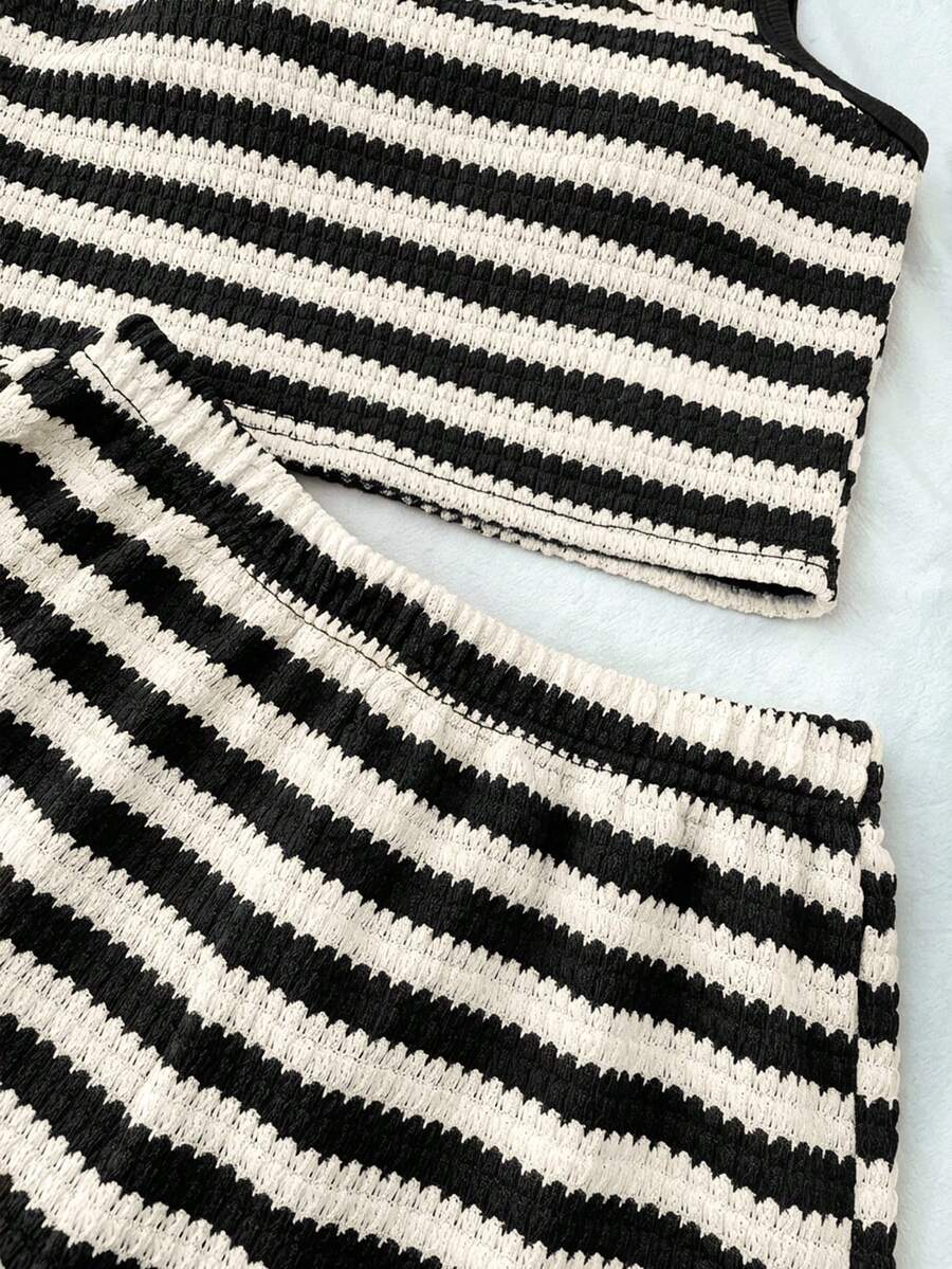 Tween girls black and white two-piece casual summer outfit featuring a rib-knit cropped top with round neck and matching shorts with contrast piping.