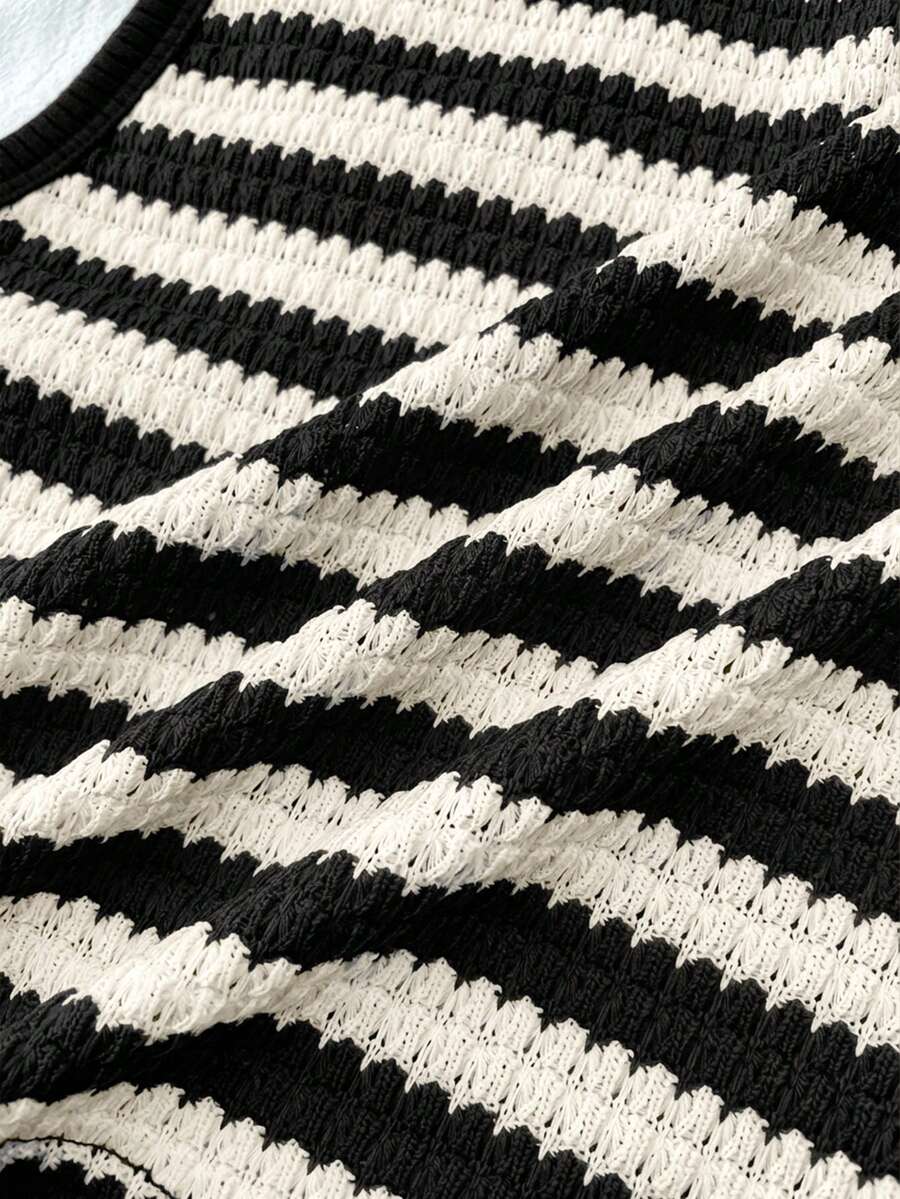Tween girls black and white two-piece casual summer outfit featuring a rib-knit cropped top with round neck and matching shorts with contrast piping.