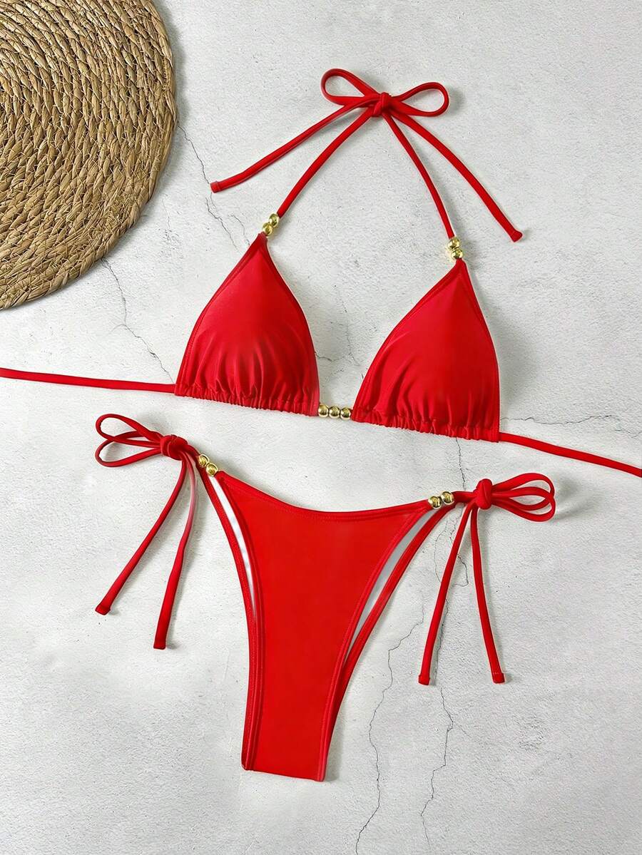 Women's black halter bikini set featuring triangle cups with gold bead decor and tie-back closure