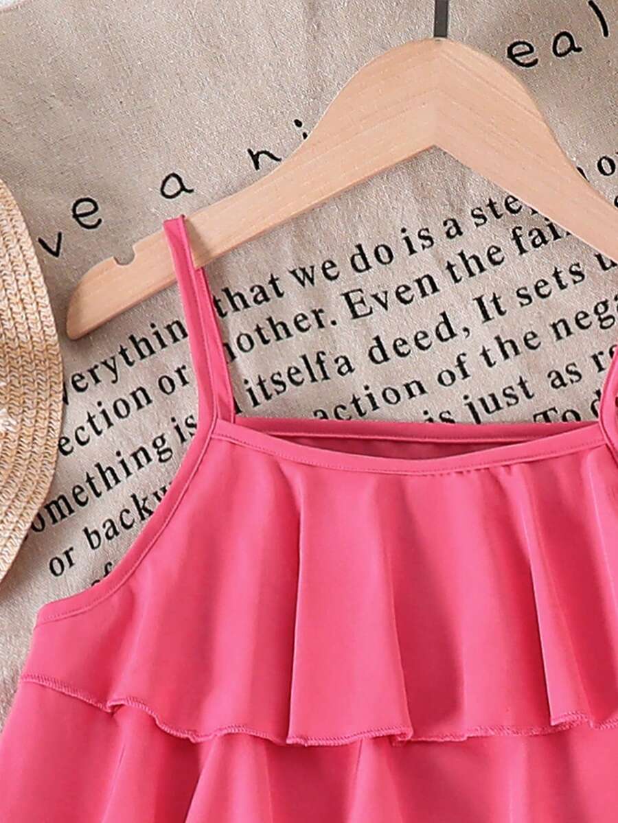 Tween girls blue 2-piece vacation outfit set featuring a tiered ruffle spaghetti strap camisole and loose high-waist pants.