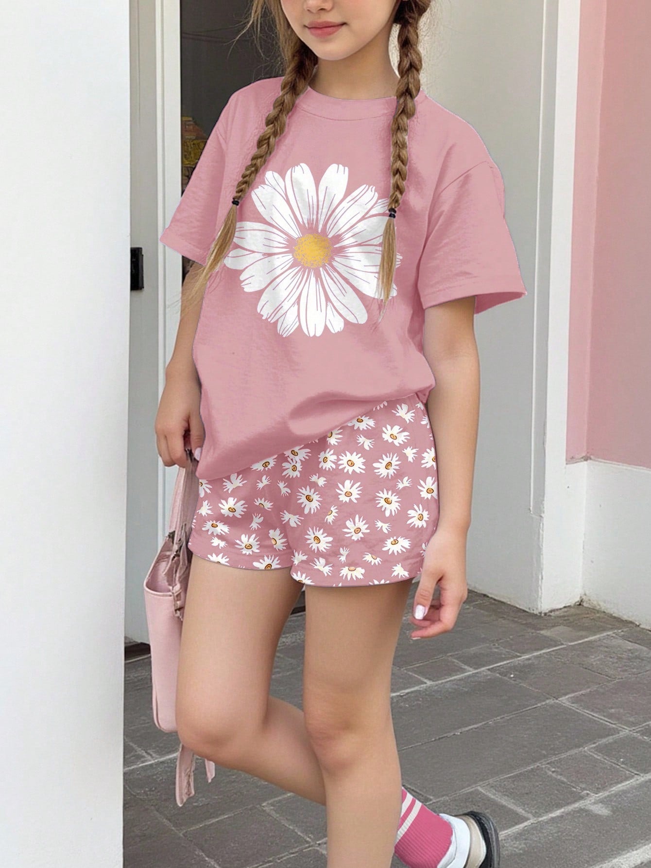 Tween girls 2-piece summer casual outfit featuring a multicolor seashell print short sleeve T-shirt with drop shoulders and matching loose fit shorts with pockets.