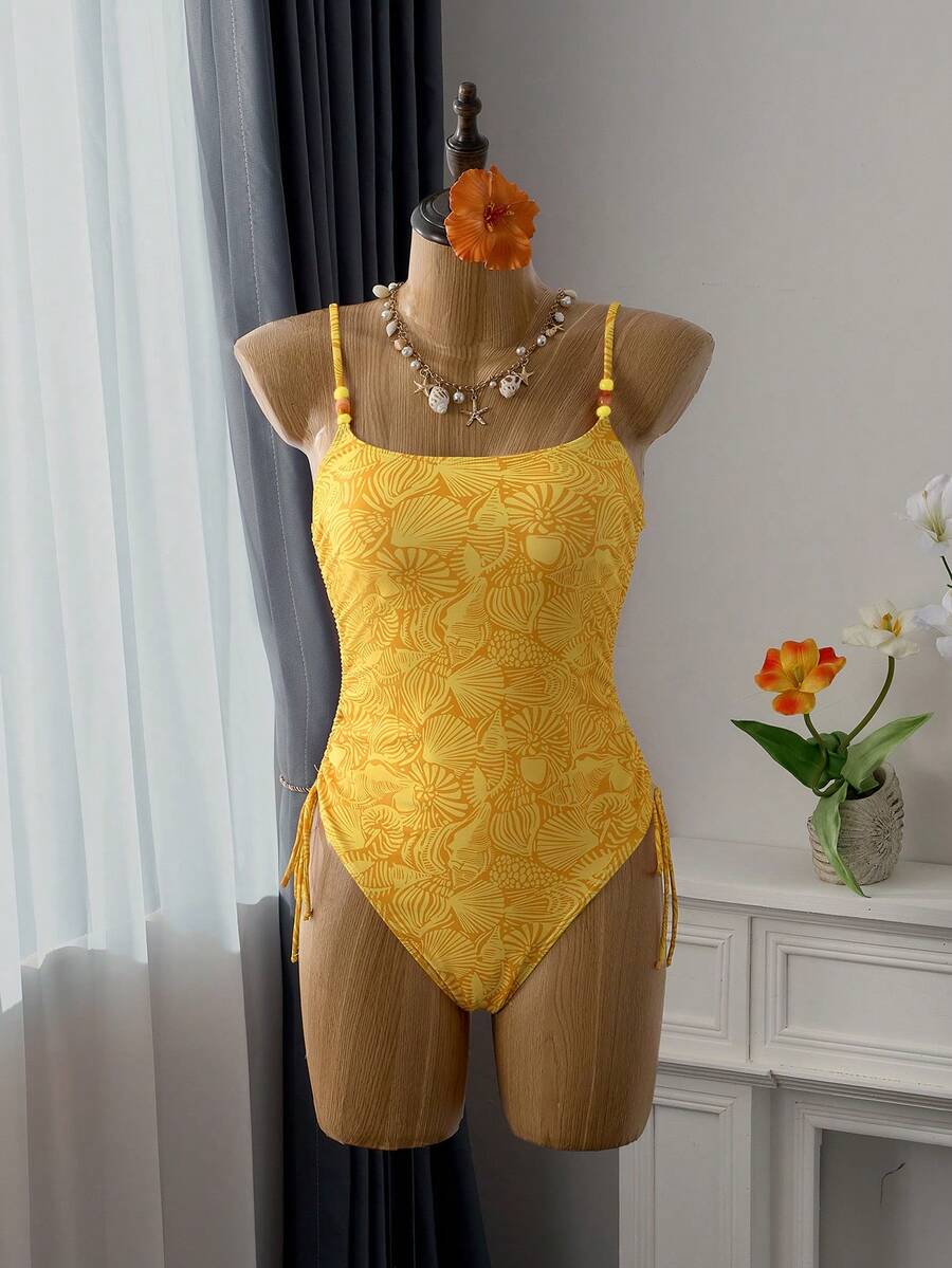 Women's blue backless one-piece swimsuit featuring spaghetti straps, wireless bra with removable padding, and drawstring details.