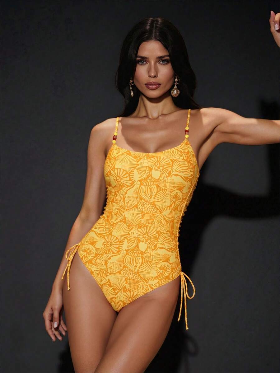 Women's blue backless one-piece swimsuit featuring spaghetti straps, wireless bra with removable padding, and drawstring details.