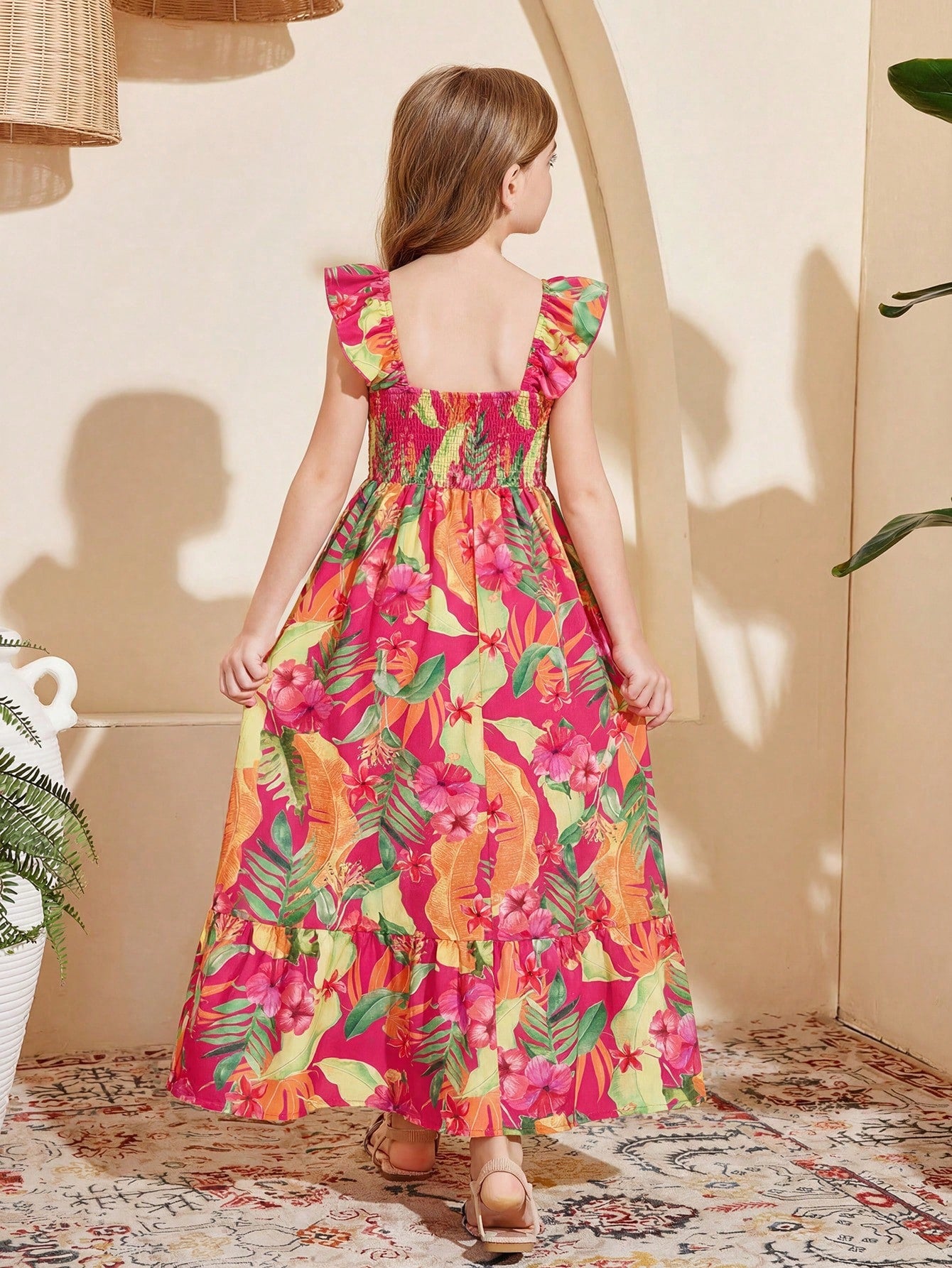 Tween girl multicolor floral vacation dress with square neck, ruffle details, shirred bodice, sleeveless A-line shape, high waist, and flounce hem.