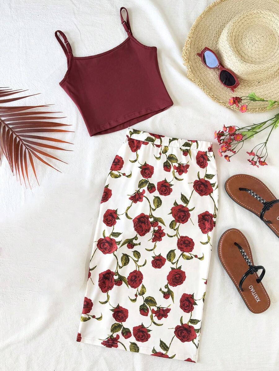 Tween girl wearing a 2-piece set featuring a black rib-knit spaghetti strap camisole top and a ruched leopard print midi skirt.