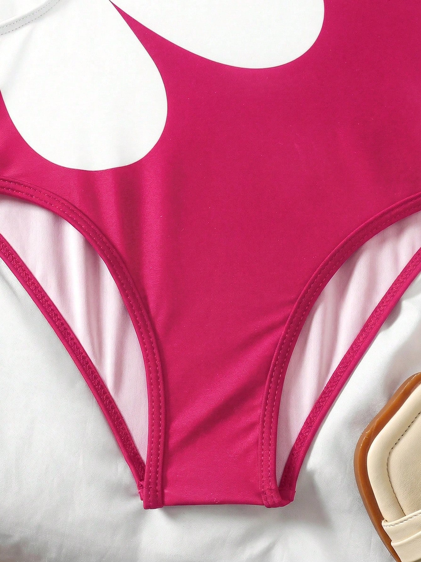 Tween girls' black and white one-piece swimsuit with striped patchwork design, scoop neck, asymmetrical cut-out detail, and fitted vacation swimwear style.