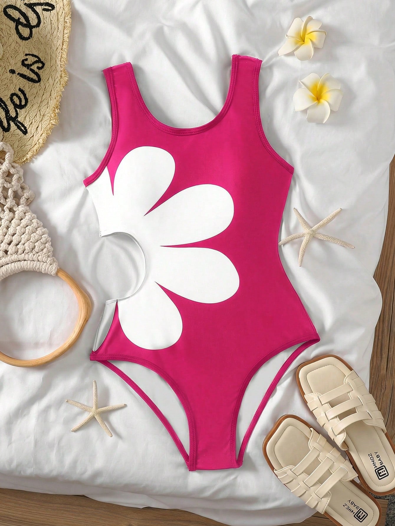 Tween girls' black and white one-piece swimsuit with striped patchwork design, scoop neck, asymmetrical cut-out detail, and fitted vacation swimwear style.
