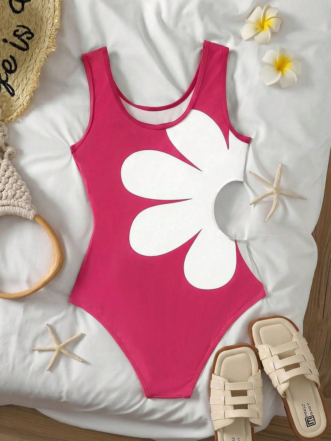 Tween girls' black and white one-piece swimsuit with striped patchwork design, scoop neck, asymmetrical cut-out detail, and fitted vacation swimwear style.