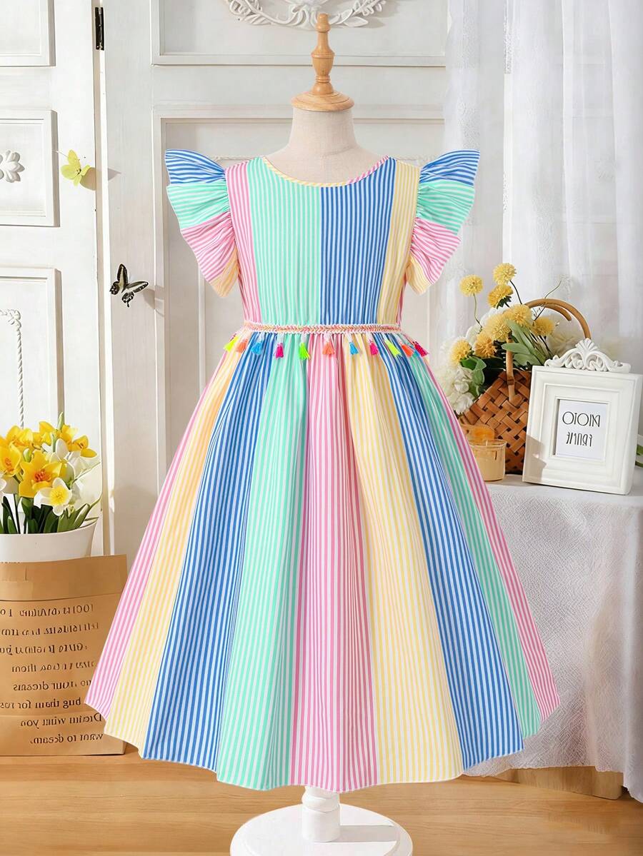 Tween girls blue short smock dress featuring flounce short sleeves, high waist flared hem, round neck, and front bow detail.
