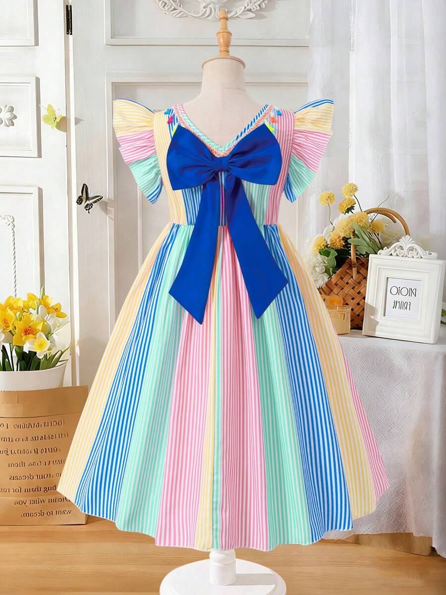 Tween girls blue short smock dress featuring flounce short sleeves, high waist flared hem, round neck, and front bow detail.