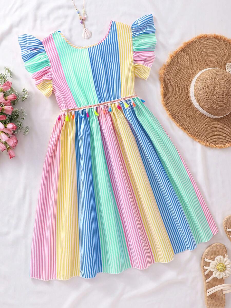 Tween girls blue short smock dress featuring flounce short sleeves, high waist flared hem, round neck, and front bow detail.