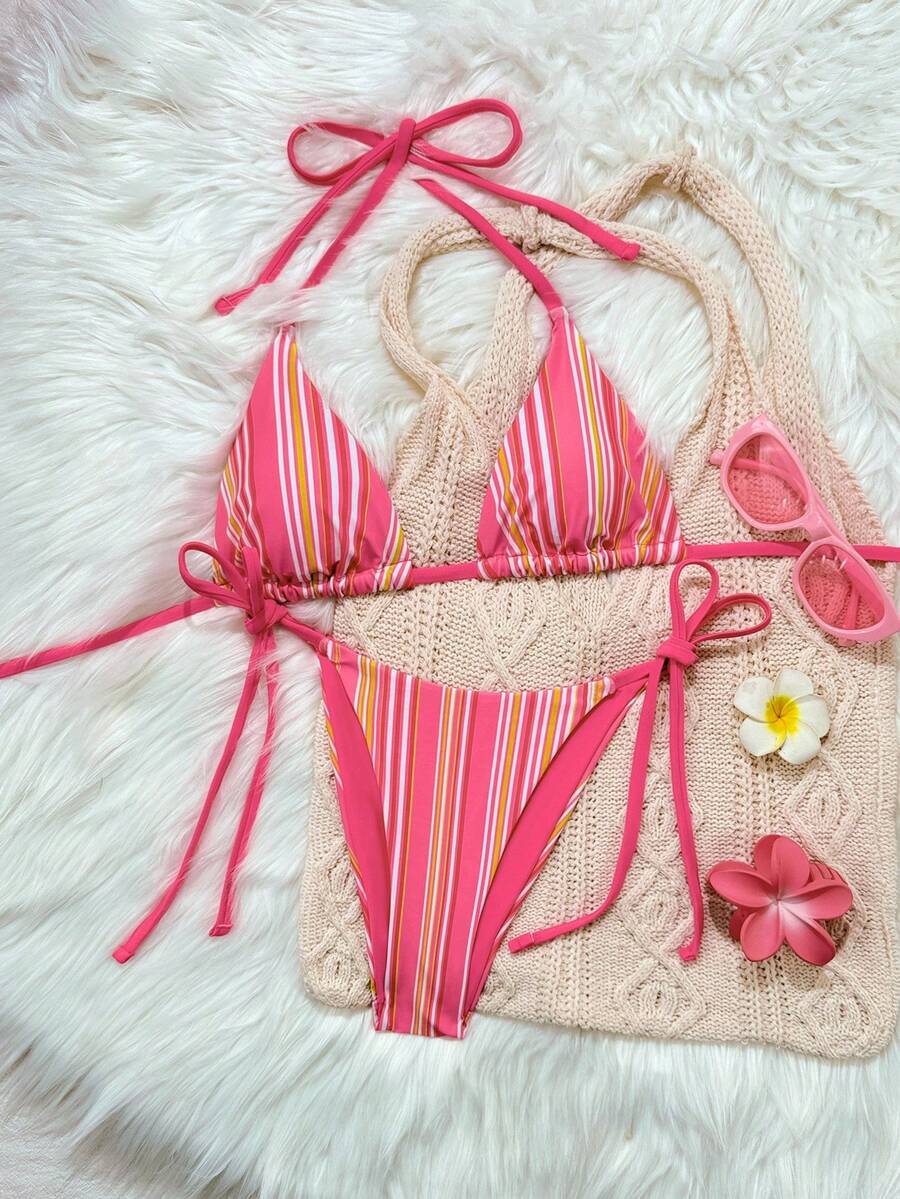 Women's black two-piece bikini set featuring a halter neck with a colorful sun pendant, triangle cups, and high-cut tie-side bottoms.