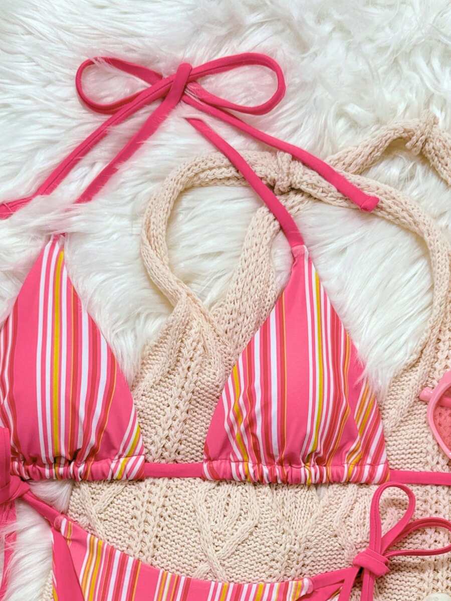 Women's black two-piece bikini set featuring a halter neck with a colorful sun pendant, triangle cups, and high-cut tie-side bottoms.