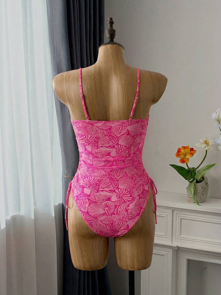 Women's blue backless one-piece swimsuit featuring spaghetti straps, wireless bra with removable padding, and drawstring details.