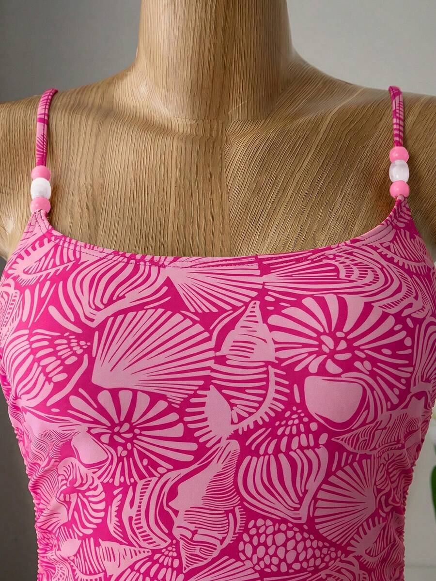 Women's blue backless one-piece swimsuit featuring spaghetti straps, wireless bra with removable padding, and drawstring details.