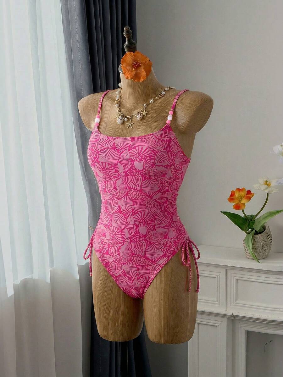Women's blue backless one-piece swimsuit featuring spaghetti straps, wireless bra with removable padding, and drawstring details.
