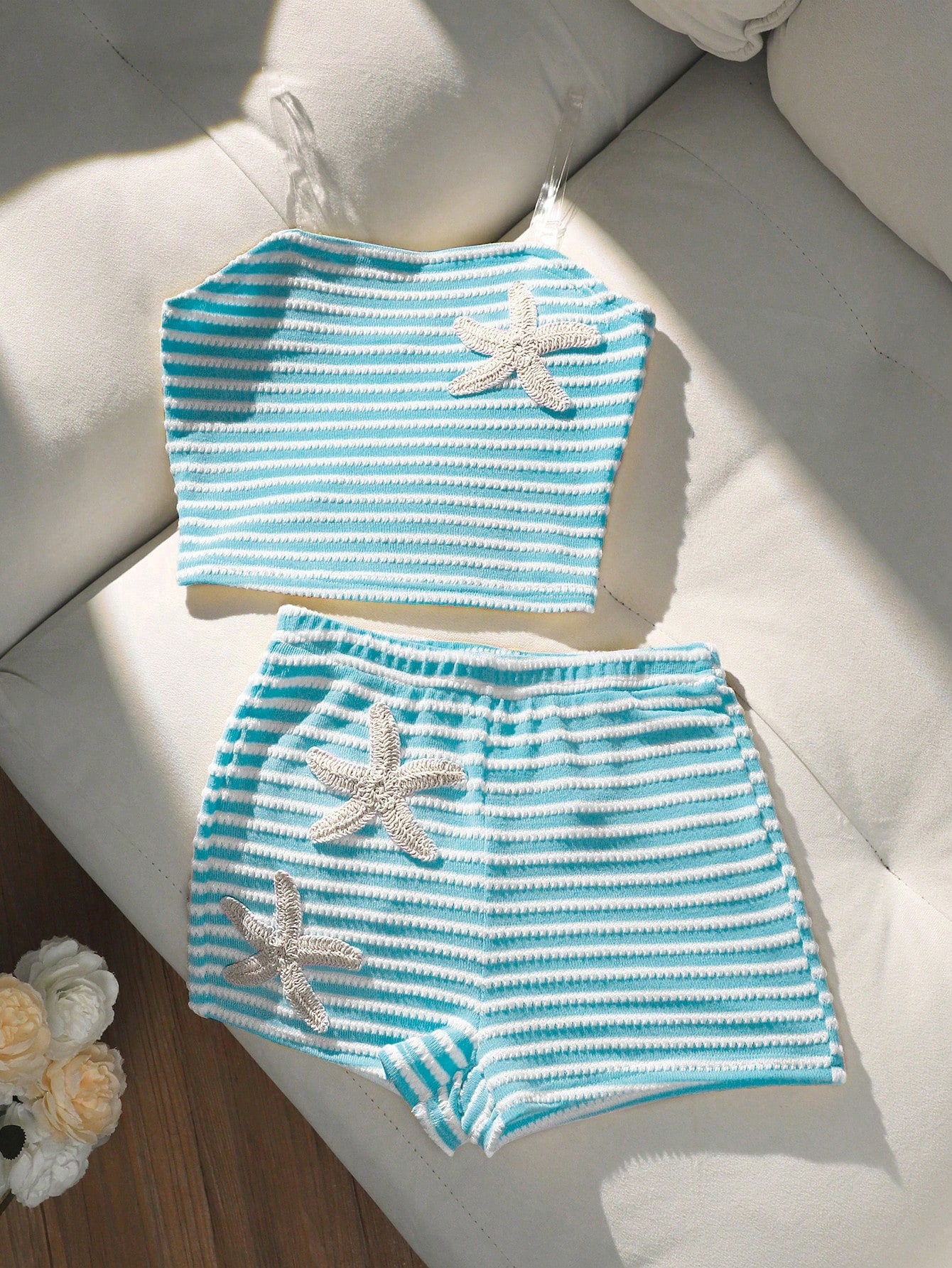 Tween girls black and white striped two-piece set featuring a spaghetti strap micro crop tank top with lettuce trim and ruffle hem paired with matching slim fit shorts.