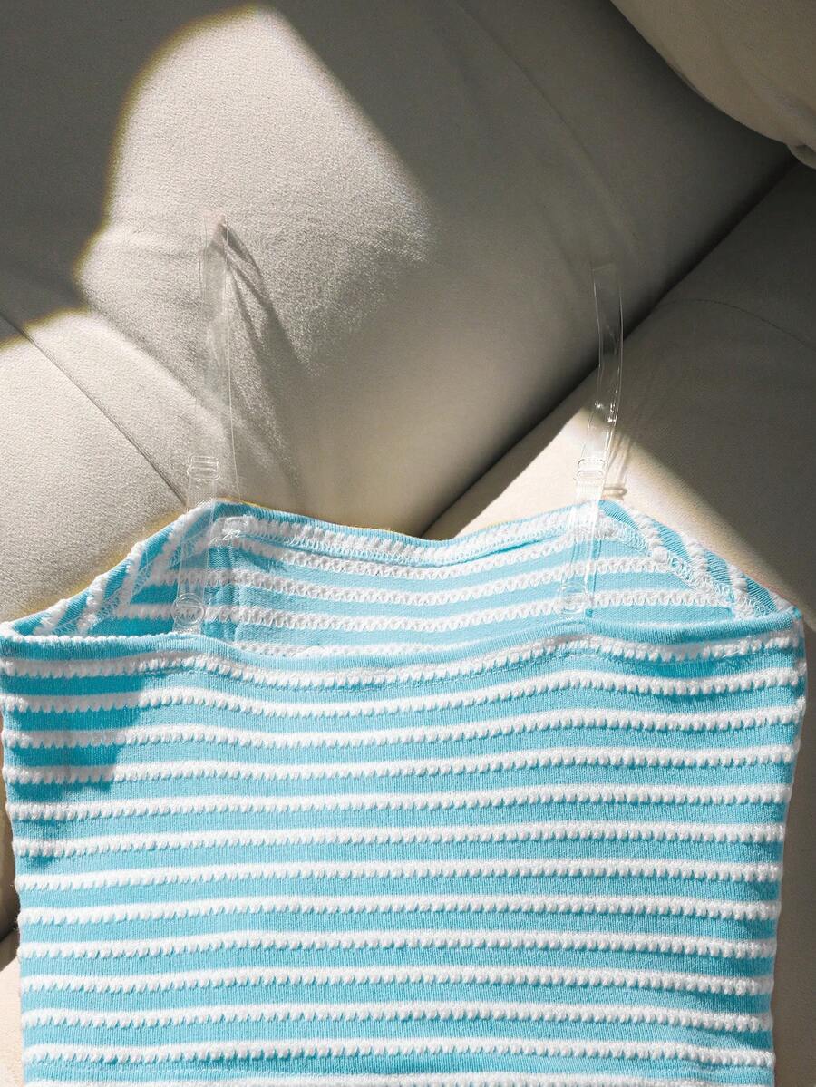 Tween girls black and white striped two-piece set featuring a spaghetti strap micro crop tank top with lettuce trim and ruffle hem paired with matching slim fit shorts.