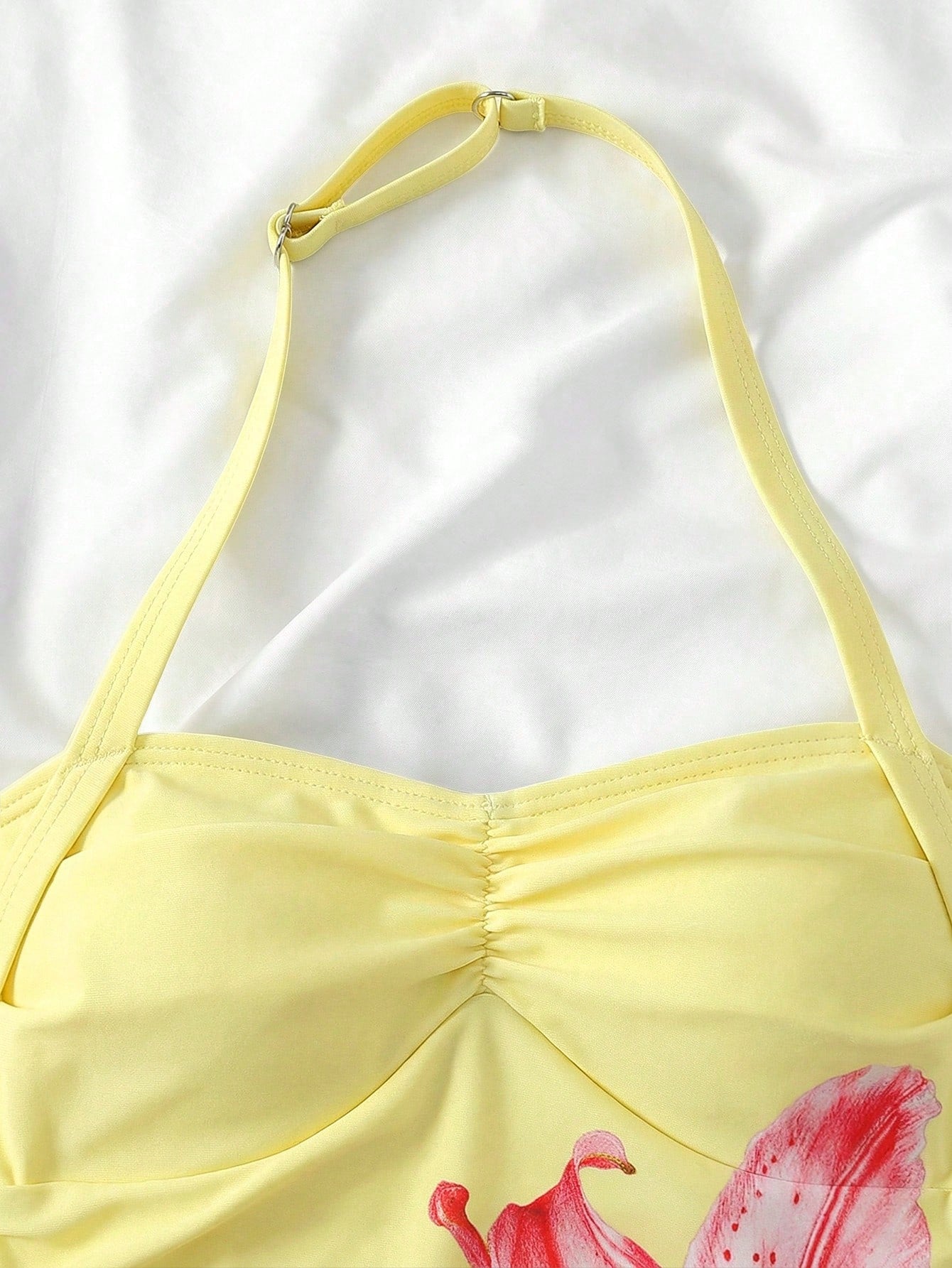Apricot one-piece swimsuit for tween girls with a halter neckline, ruffle trim, textured knit fabric, fitted shape, and starfish metal decor.