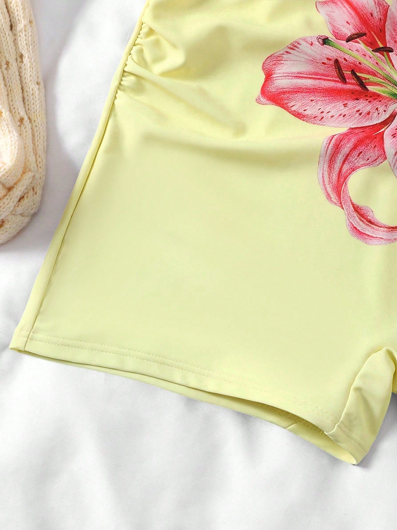 Apricot one-piece swimsuit for tween girls with a halter neckline, ruffle trim, textured knit fabric, fitted shape, and starfish metal decor.