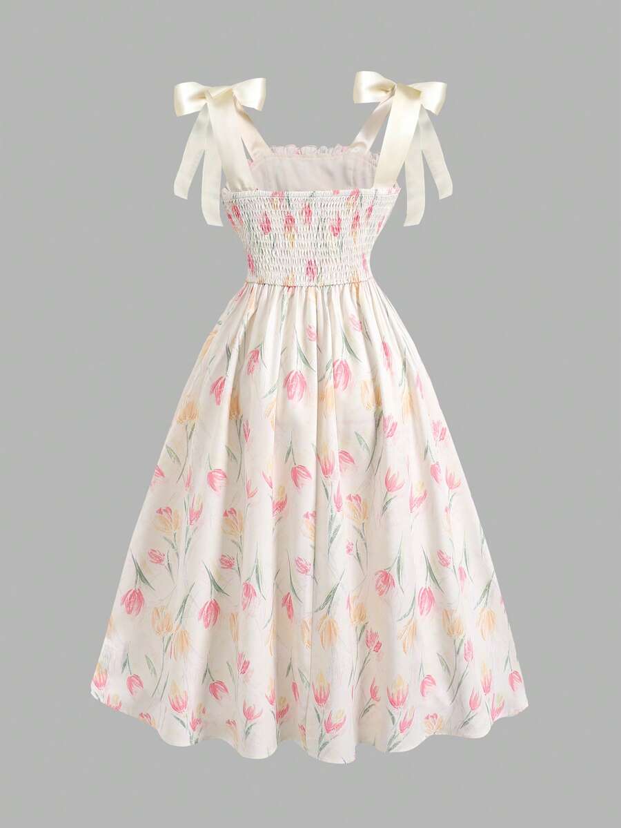 Tween girl apricot floral print midi dress with ruffle shoulder straps, shirred detail, and high waist A-line fit.
