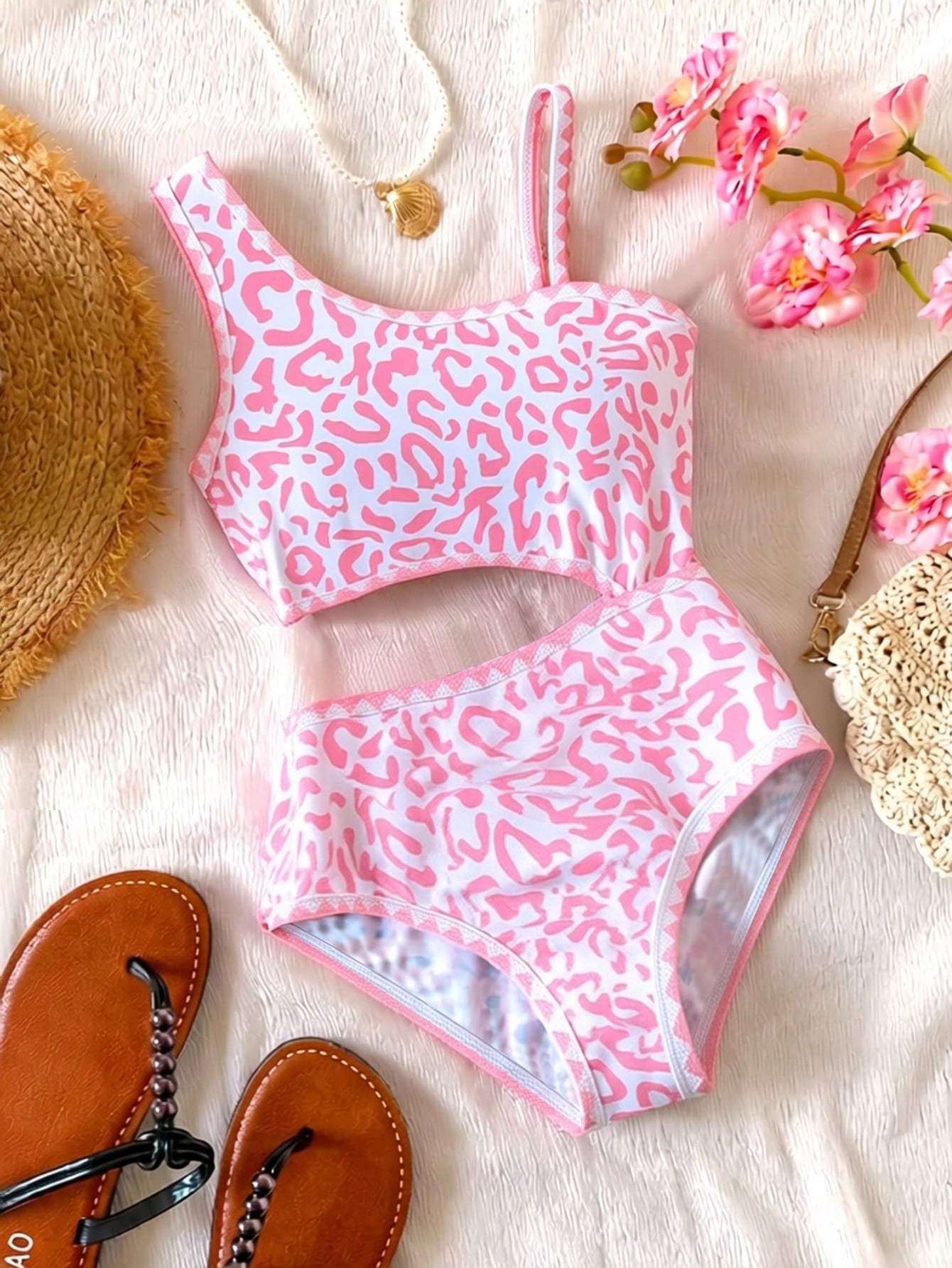 Tween girls one-piece swimsuit featuring an asymmetric neckline, pendant decor, plain design, wireless bra, high-cut bottom, and medium-stretch fabric.