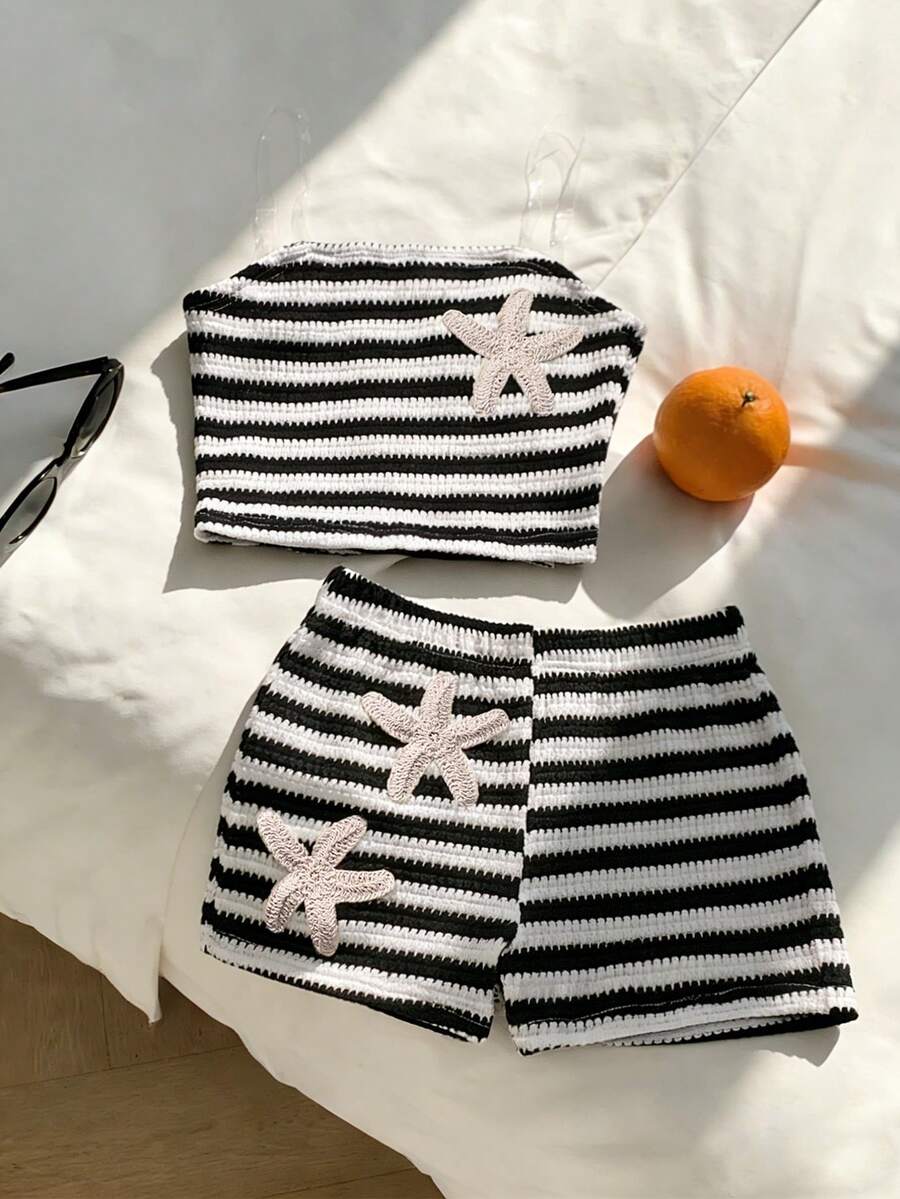 Tween girls black and white striped two-piece set featuring a spaghetti strap micro crop tank top with lettuce trim and ruffle hem paired with matching slim fit shorts.