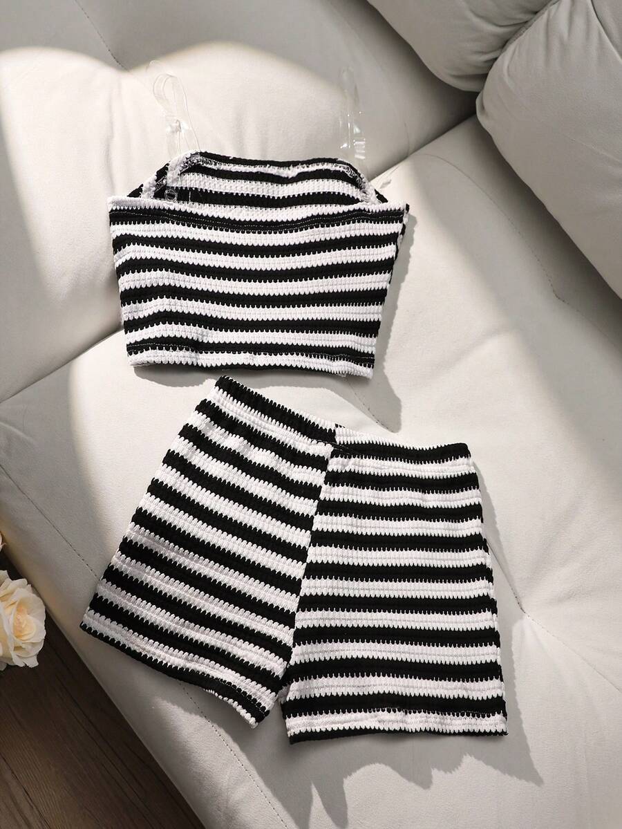 Tween girls black and white striped two-piece set featuring a spaghetti strap micro crop tank top with lettuce trim and ruffle hem paired with matching slim fit shorts.