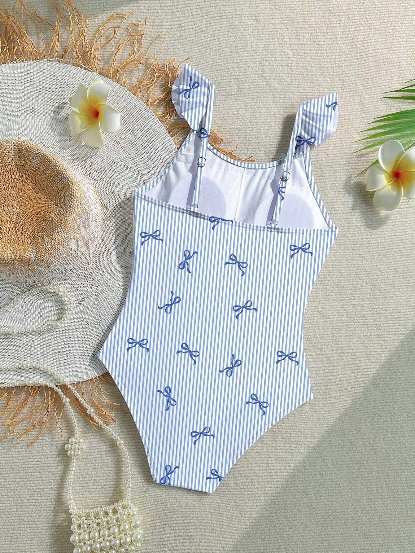Tween girls one-piece swimsuit featuring an asymmetric neckline, pendant decor, plain design, wireless bra, high-cut bottom, and medium-stretch fabric.