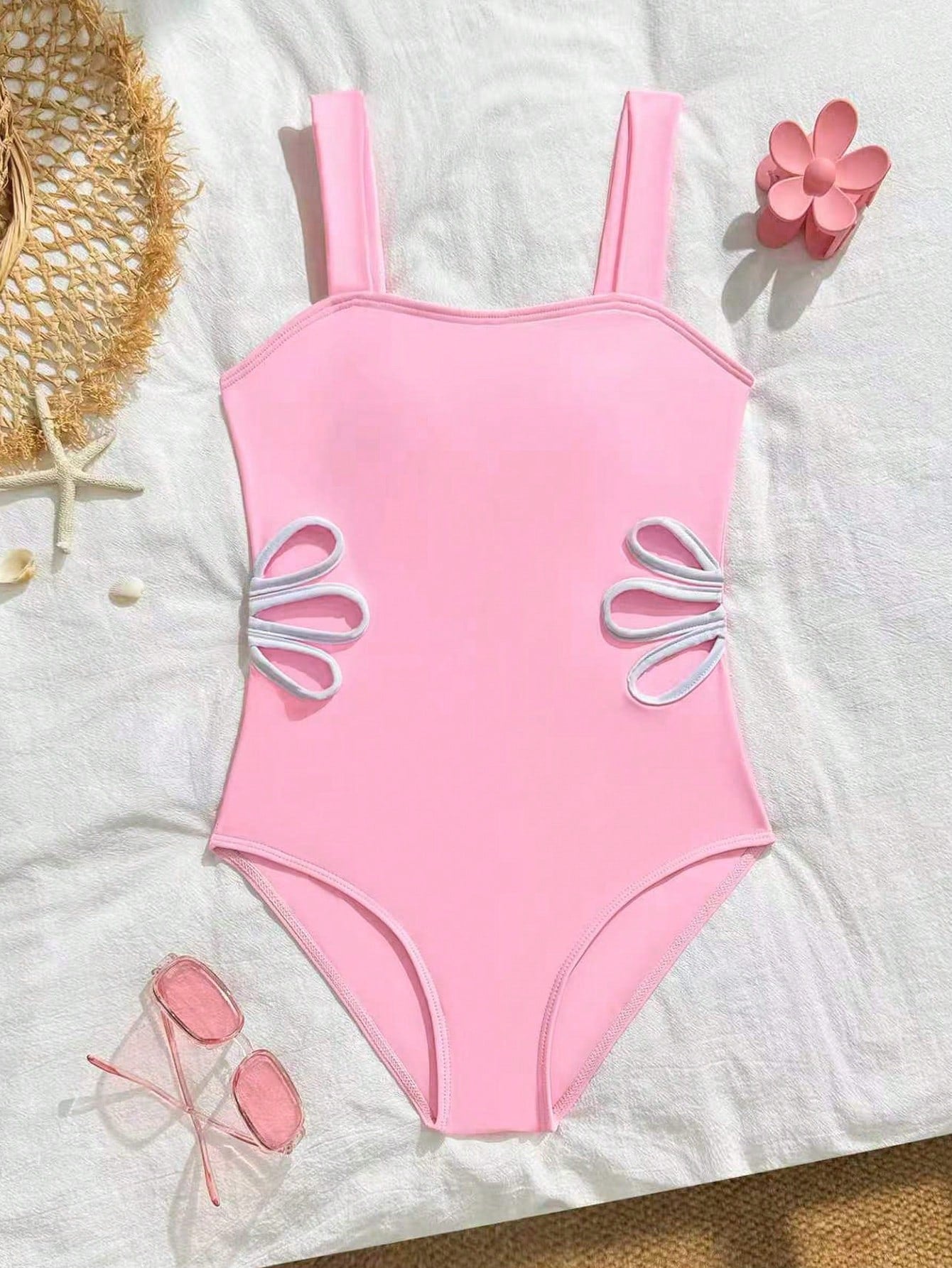 Tween girls one-piece swimsuit with a floral plant print, spaghetti straps, and a mid-waist fit in black.