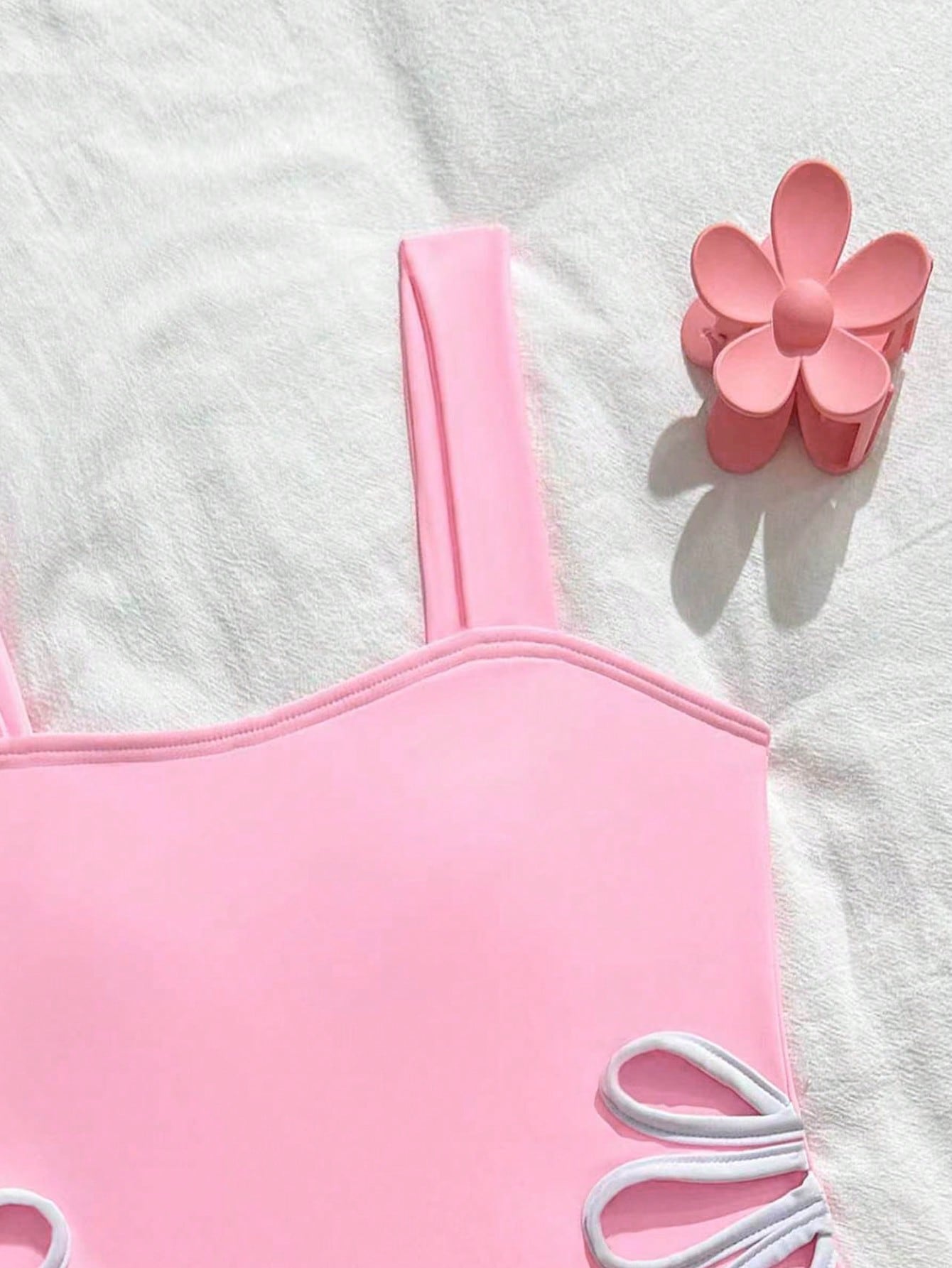 Tween girls one-piece swimsuit with a floral plant print, spaghetti straps, and a mid-waist fit in black.