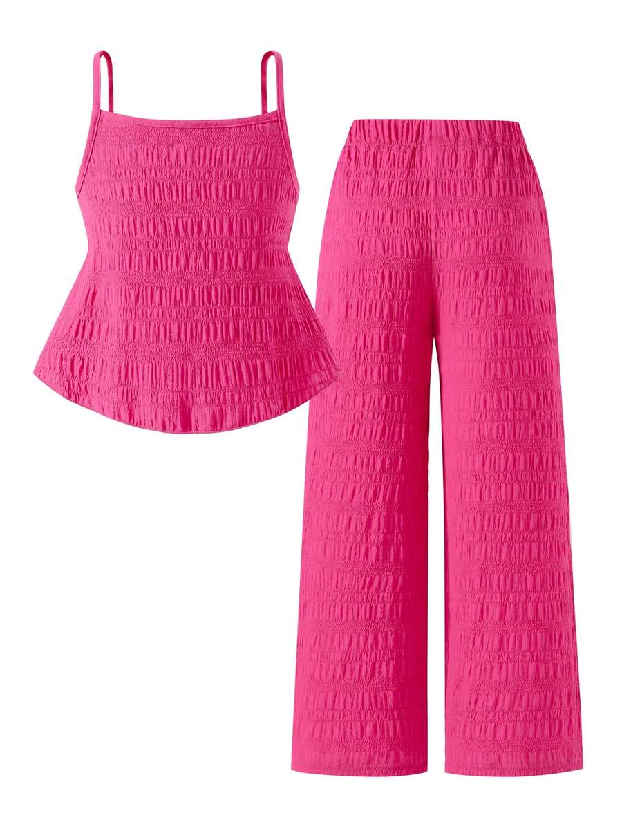 Tween girl wearing an apricot 2-piece outfit set featuring a shirred spaghetti strap short cami top and matching wide-leg long pants.