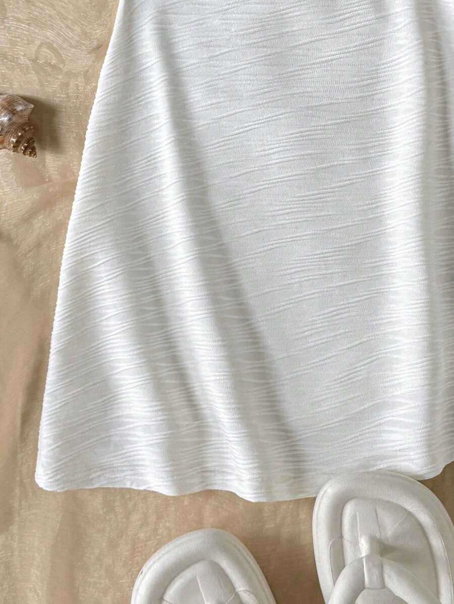 Apricot tween girls sleeveless halter cami dress with appliques, bow front, zipper detail, high waist, flared hem, and short slim fit design.