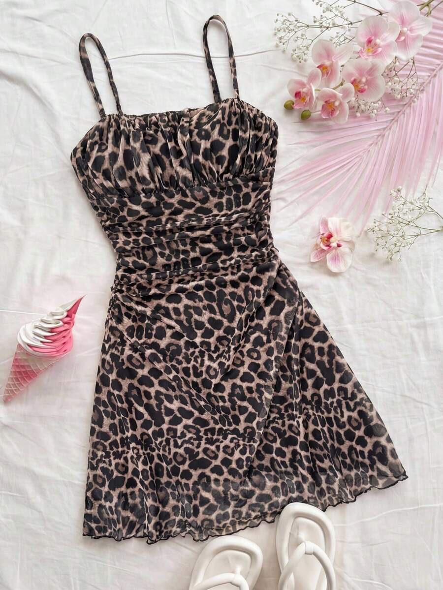 Tween girl yellow mini sundress with large pink floral hibiscus print, spaghetti straps, high waist, flared hem, and sleeveless cami style for summer beach wear