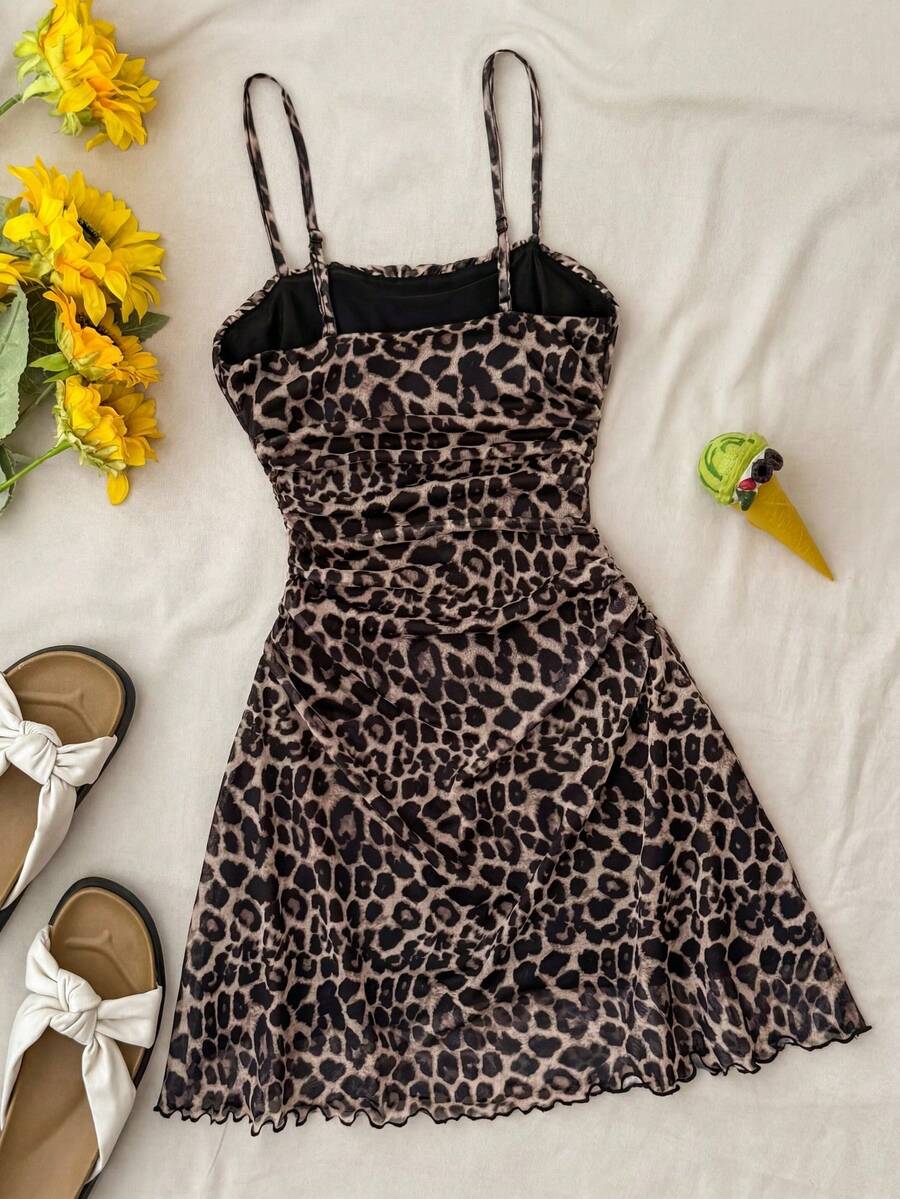 Tween girl yellow mini sundress with large pink floral hibiscus print, spaghetti straps, high waist, flared hem, and sleeveless cami style for summer beach wear